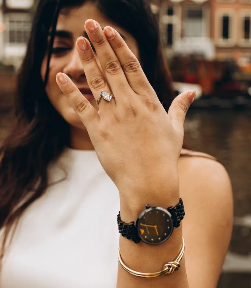 Woman laughing and showing her engagement ring after the proposal, Amsterdam