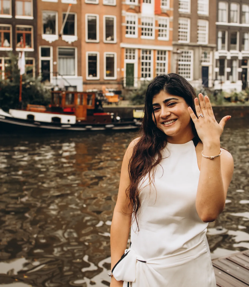 Newly engaged woman showing her ring by an Amsterdam canal