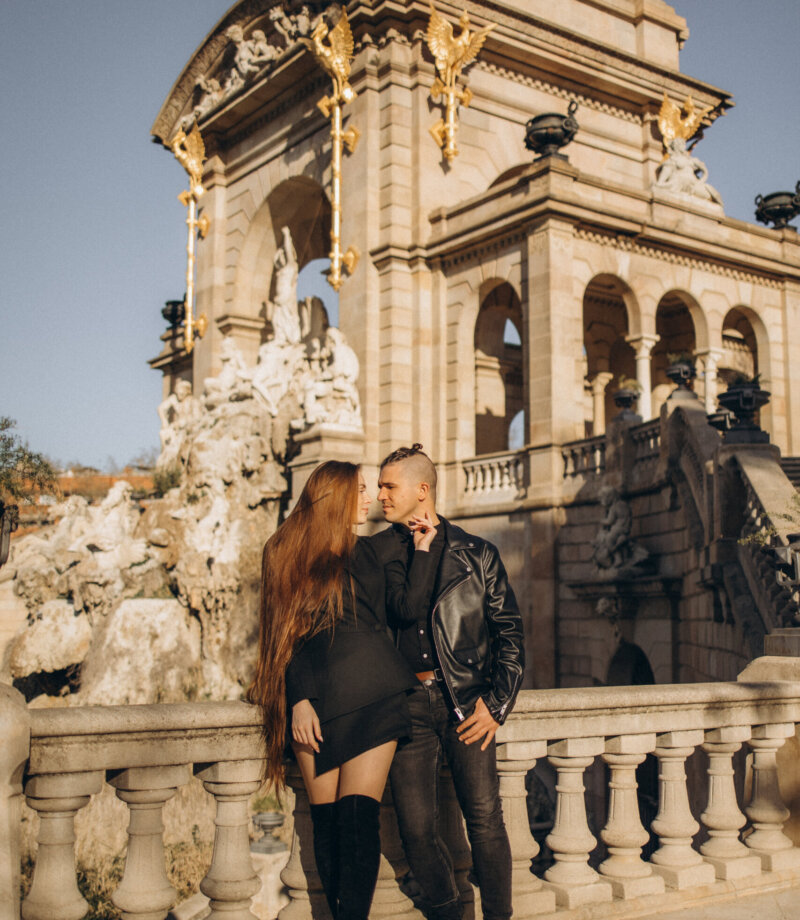 Couple in black leather posing on the balustrade of the Cascada Monumental fountain in Ciutadella Park, Barcelona