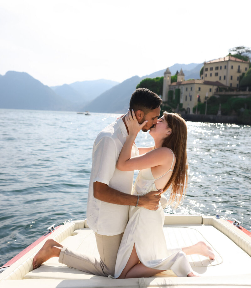 Couple kissing on a boat near Villa del Balbianello, Lake Como