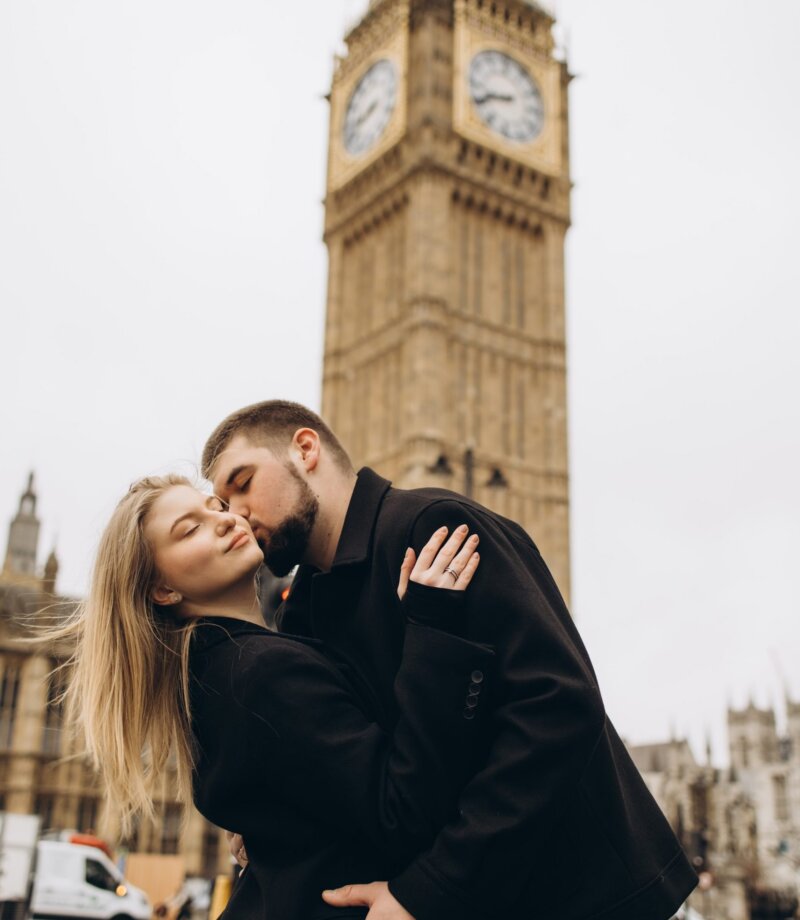 Couple kissing at the foot of Big Ben, Westminster, London