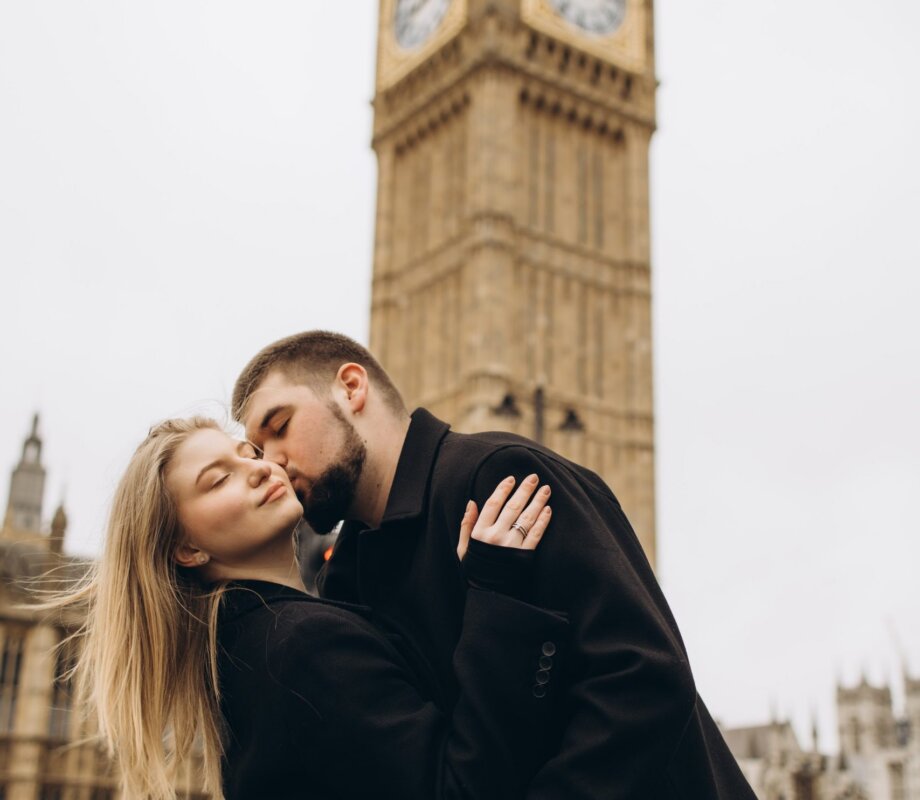 Couple kissing at the foot of Big Ben, Westminster, London