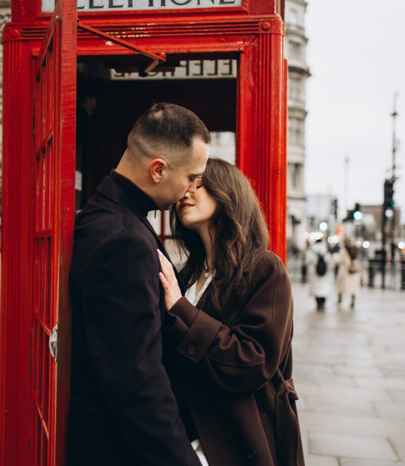 Couple kissing in the doorway of a red telephone box, Westminster, London
