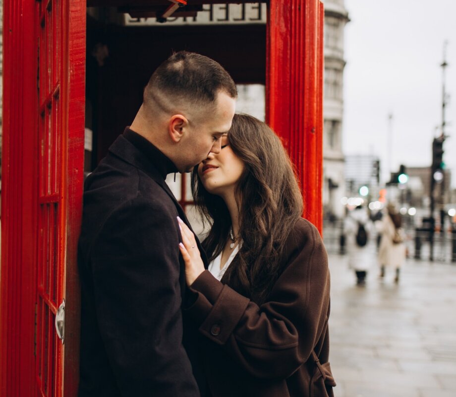 Couple kissing in the doorway of a red telephone box, Westminster, London