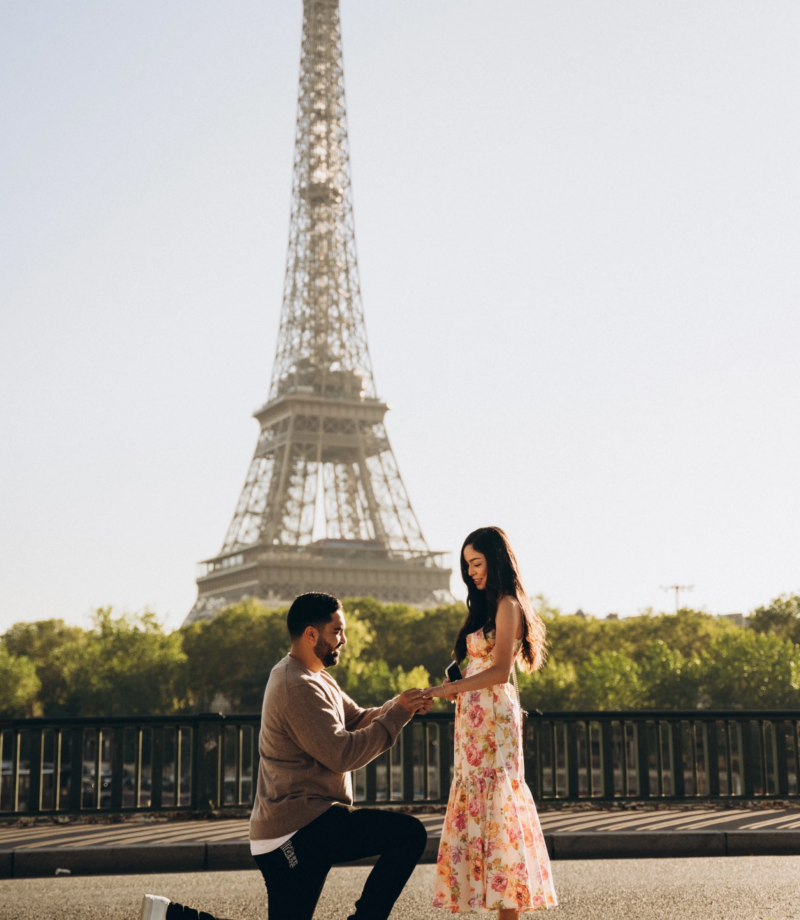 Man on one knee proposing in front of the Eiffel Tower, Paris