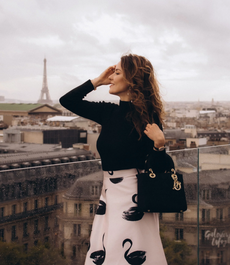 Woman posing on the Galeries Lafayette rooftop with the Paris skyline, Paris