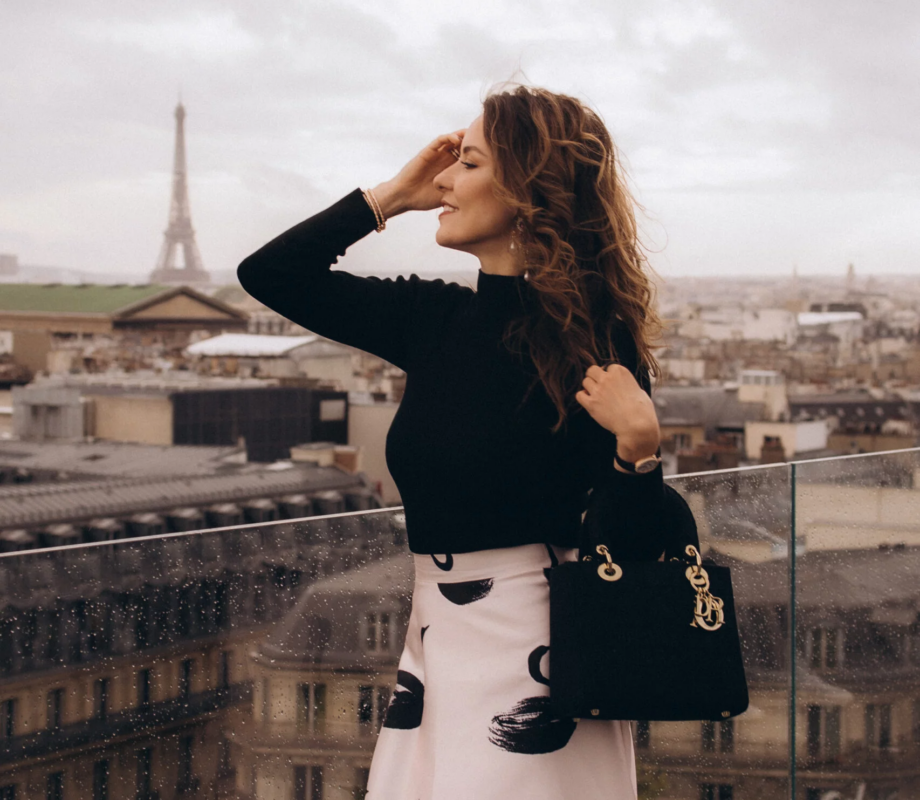 Woman posing on the Galeries Lafayette rooftop with the Paris skyline, Paris