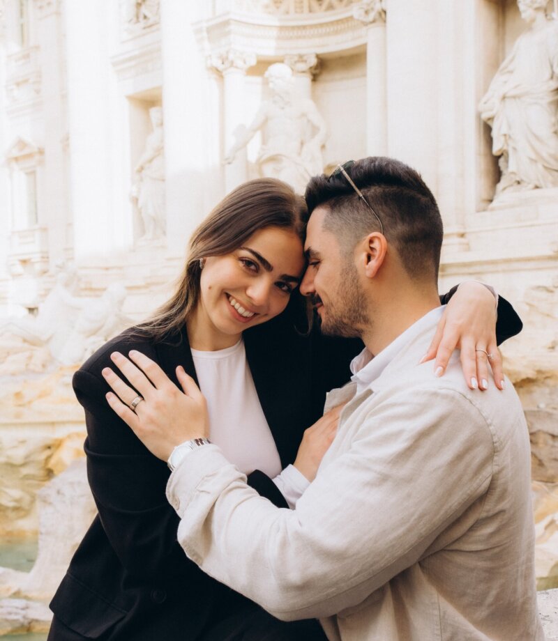 Couple embracing at the Trevi Fountain in the morning, Rome