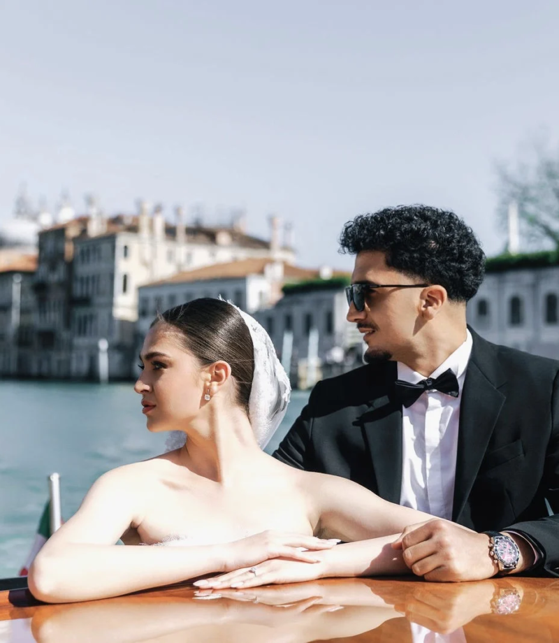 Bride and groom on a water taxi passing Santa Maria della Salute, Venice